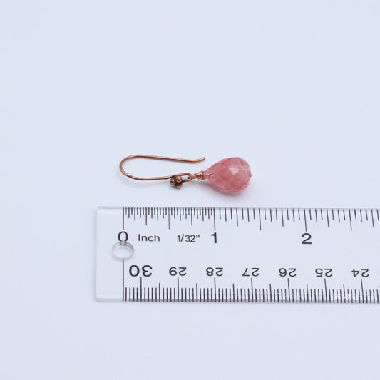 Earrings feature an antique copper fish-hook wire paired with a faceted cherry quartz teardrop.