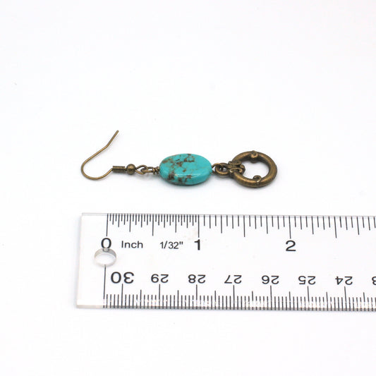 Turquoise and bronze earrings on a white background.