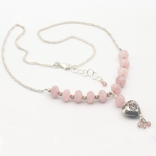 Sterling Silver Heart and rope chain showcases a stunning arrangement of Rose Quartz gemstones, secured with a lobster clasp closure.