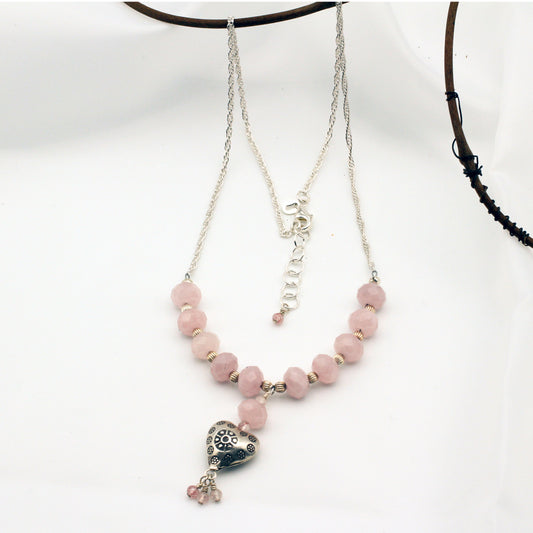 Sterling Silver Heart and rope chain showcases a stunning arrangement of Rose Quartz gemstones, secured with a lobster clasp closure.