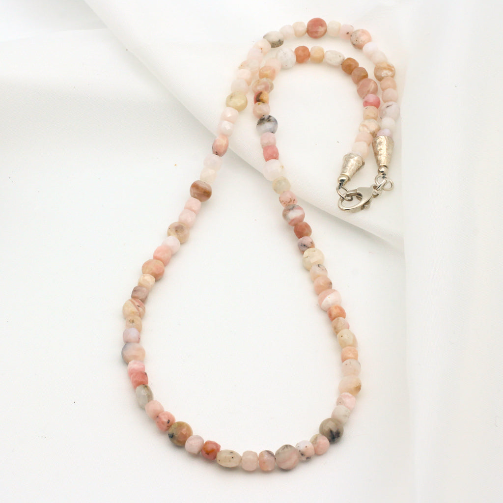 This handmade single strand beaded necklace is crafted with faceted Pink Opal Gemstones and Sterling Silver findings.