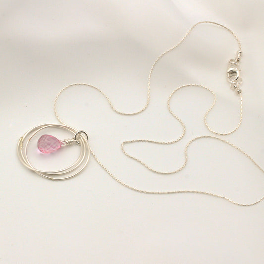 Pink Quartz Briolette hangs delicately from a triple loop frame. Made entirely of sterling silver, finished with a lobster claw clasp.