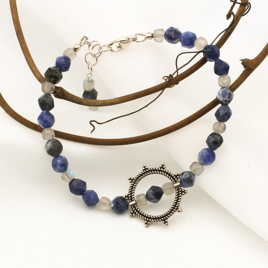 Sodalite and Labradorite Gemstones surrounding a Sterling Silver Sunburst, finished with  Sterling Silver Adjustable Chain and Lobster Claw clasp.