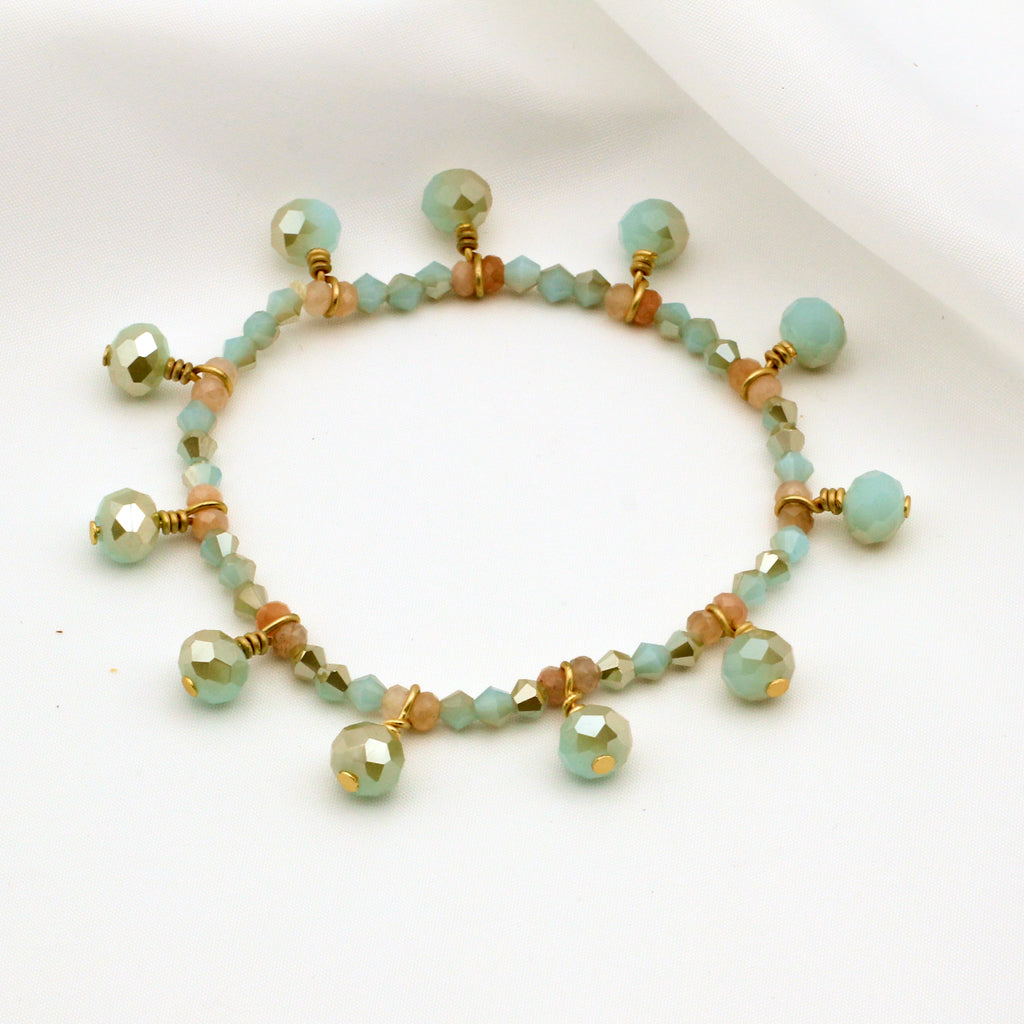 This handmade elastic bracelet is a beautiful combination of mint green crystal beads and sunstone gemstone beads. The mint green crystals provide a refreshing pop of color, while the sunstone gemstones add a warm and glowing touch. The elastic design allows for a comfortable and adjustable fit, making it a great accessory for everyday wear or special occasions.