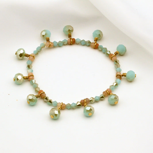 Mint green crystal and sunstone gemstone bracelet with gold accents; stretch fit, nickel-free, and perfect for everyday wear.