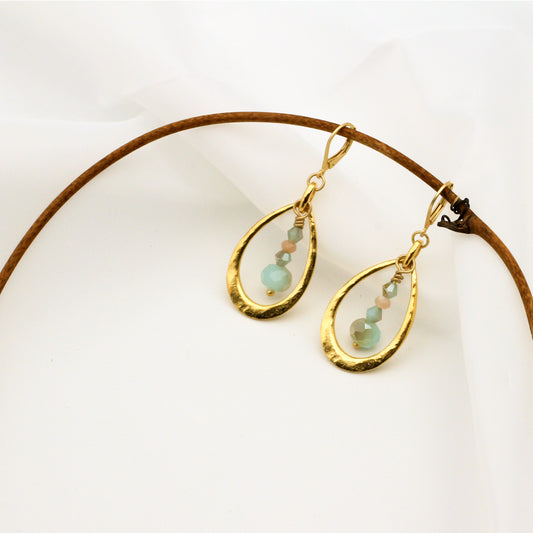 Matte gold hoops with mint green crystals and sunstone gemstones; 2-inch length with secure lever-back ear wires.