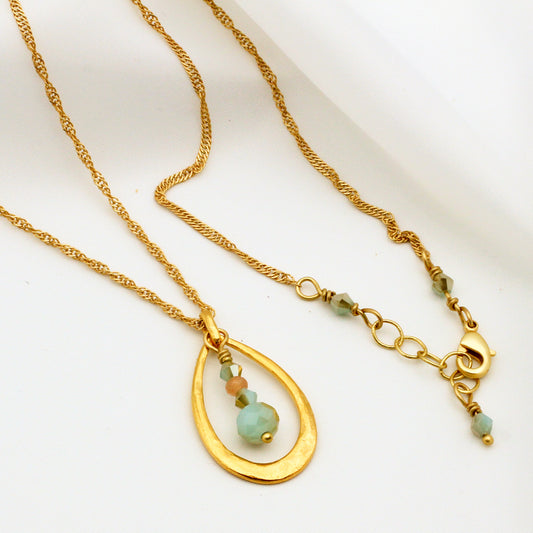 Mint crystal necklace with sunstone accent and matte gold metals; 24-inch length with 1-inch extender, modern and elegant design.