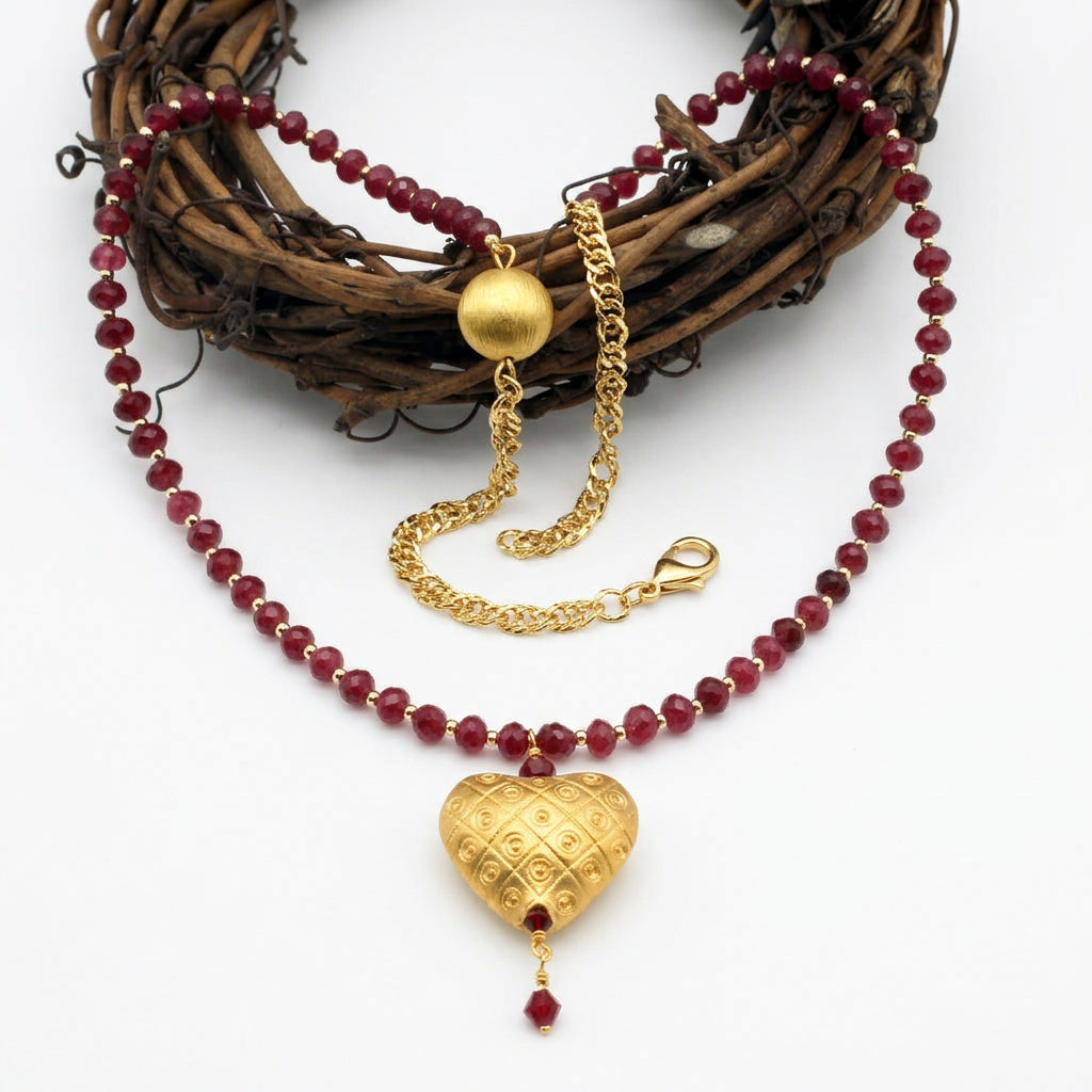 Gold vermeil heart necklace with red jade and ruby crystal accents.
