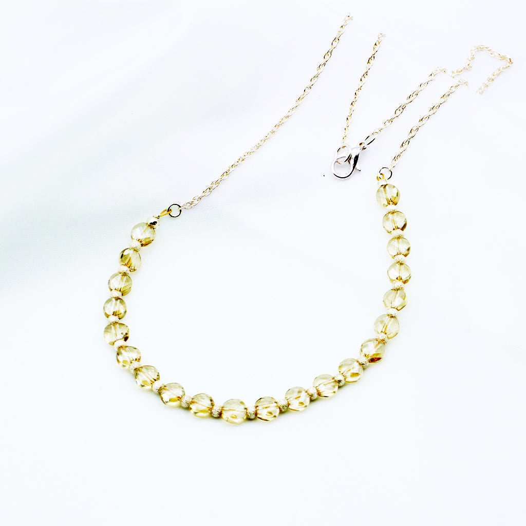 This finely crafted necklace showcases radiant champagne-hued Crystals paired with polished sterling silver accents. Finished with a reliable lobster claw clasp.