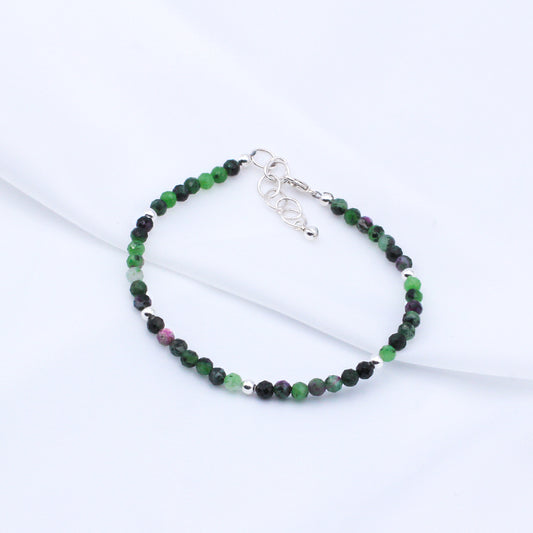 Ruby Zoisite gemstones and sterling silver metals, finished with a secure lobster clasp and chain extender, making it a perfect fit for any occasion.