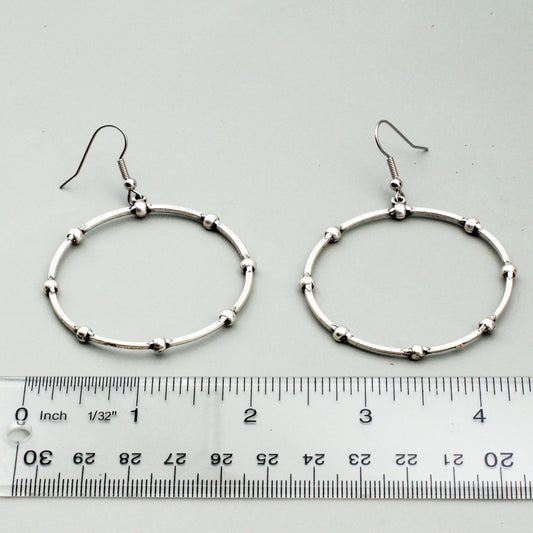 A textured Pewter and Silver-electroplated hoop design.
