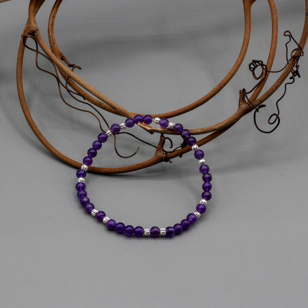 Bracelet features a stunning blend of Amethyst gemstones paired with Pewter spacer beads. Its elastic construction ensures a flexible and comfortable fit.