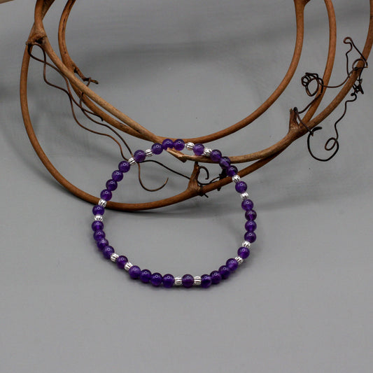Bracelet features a stunning blend of Amethyst gemstones paired with Pewter spacer beads. Its elastic construction ensures a flexible and comfortable fit.