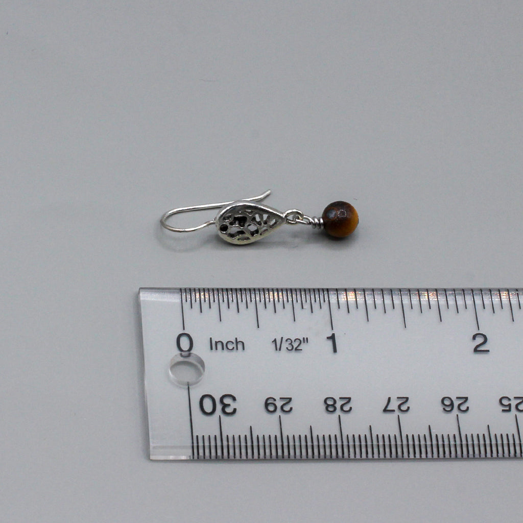 Tiger eye gemstone that gracefully moves from a delicate filigree fish-hook ear-wire. They present a harmonious blend of vivid color and intricate metalwork.