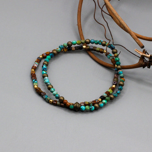 Bracelet presents dual layered strands of African Turquoise gemstones threaded on a resilient elastic cord, accented with Antique Bronze.