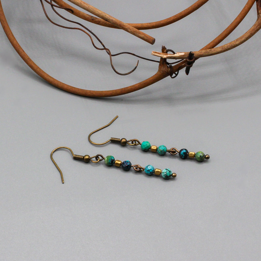 African Turquoise gemstones suspended from Antique Bronze ear-wires enhances the design.
