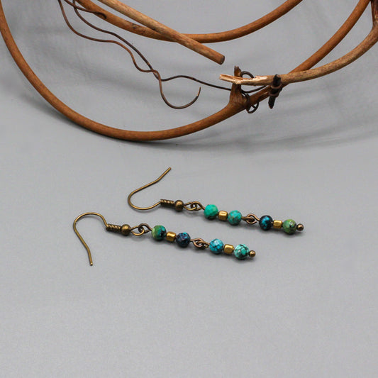 African Turquoise gemstones suspended from Antique Bronze ear-wires enhances the design.