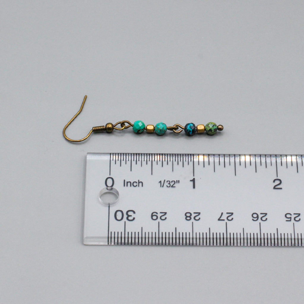 African Turquoise gemstones suspended from Antique Bronze ear-wires enhances the design.