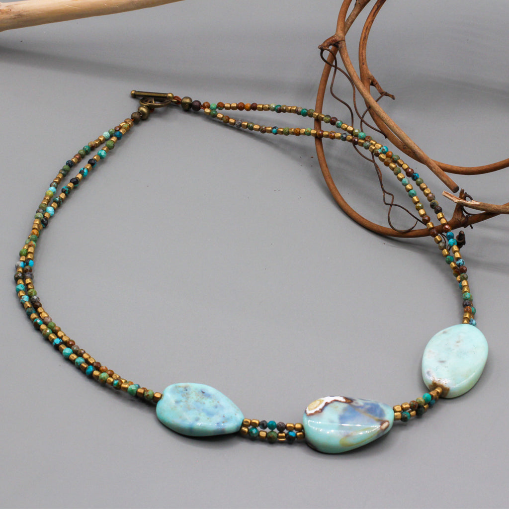 Three striking Agate focal stones, elegantly framed by double rows of vibrant African Turquoise gemstones.