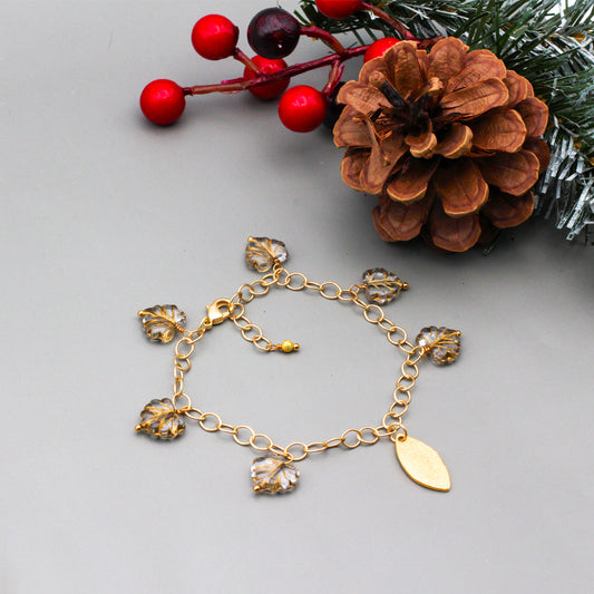 Golden and Crystal Czech fire polish leaf beads linked on the chain & a textured gold focal point. Finished with a secure lobster claw clasp.