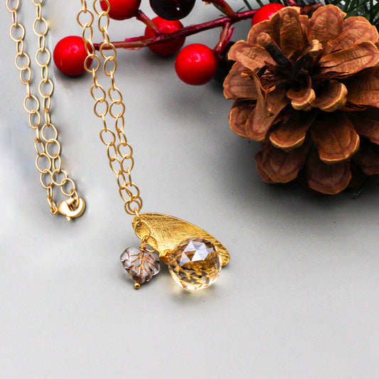 Crystal Czech fire polish leaf bead  on a chain with a textured gold focal and a faceted briolette.