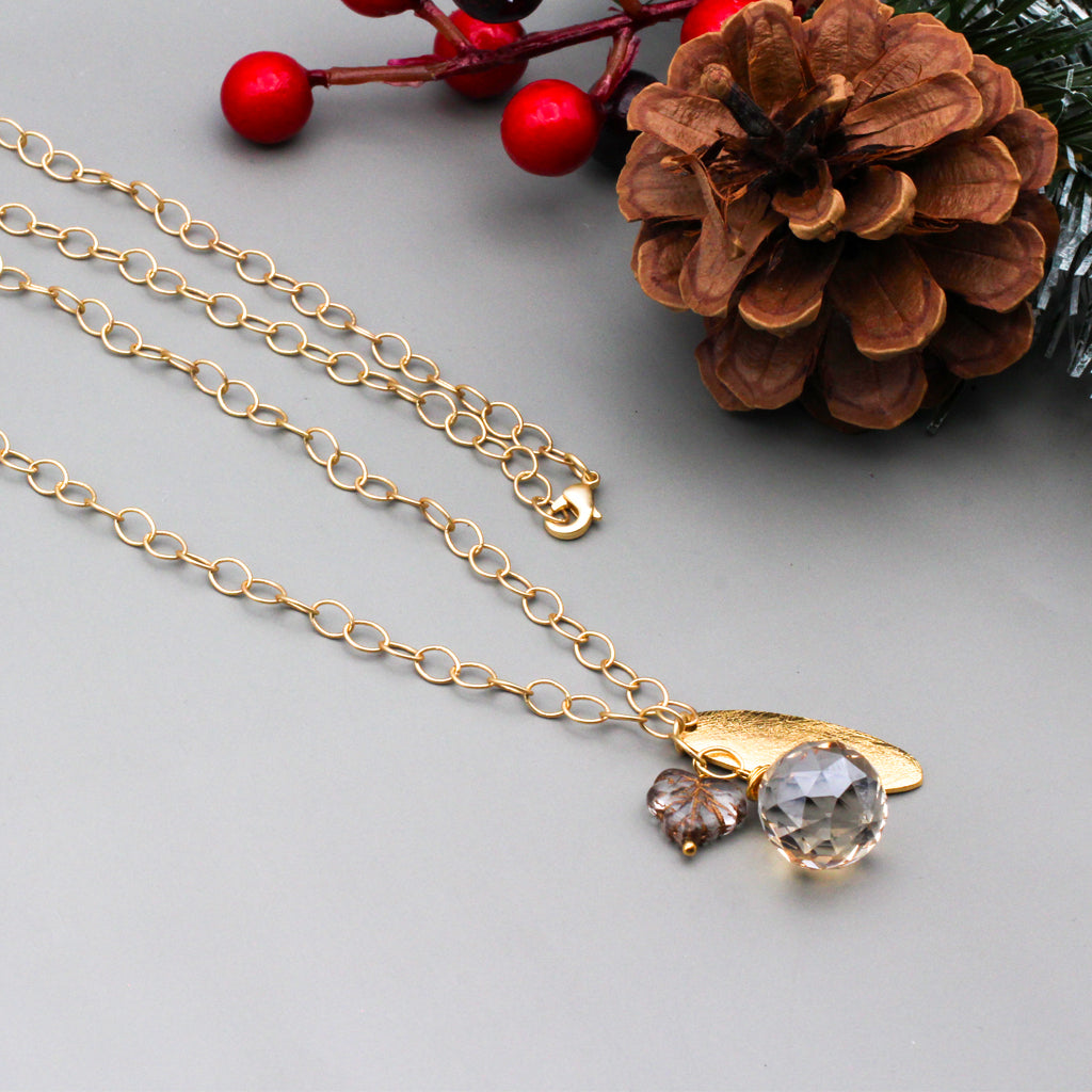 Crystal Czech fire polish leaf bead  on a chain with a textured gold focal and a faceted briolette.