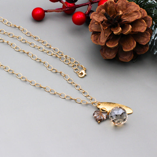 Crystal Czech fire polish leaf bead  on a chain with a textured gold focal and a faceted briolette.