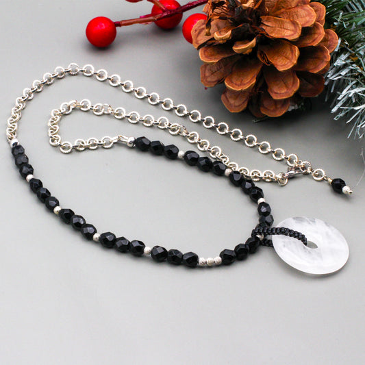 Czech glass faceted beads & a focal point, crystal quartz donut, hand-woven seed bead bail. Finished with a lobster claw clasp.