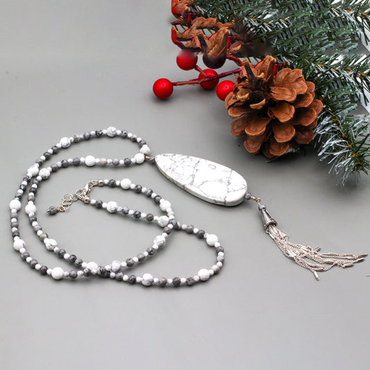 Howlite pendant encircled by Picasso Jasper Gemstones. Fastens with a lobster clasp.