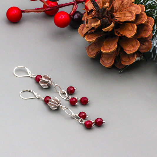 Dangle earrings showcase a combination of Faceted Agate Gemstones and a Sterling Silver chain, highlighted by a textured centerpiece. Completed with secure lever-back ear wires.