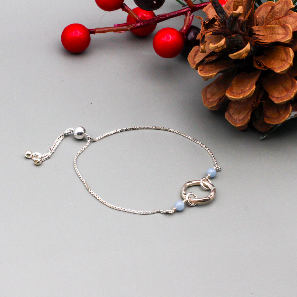 Angelite Gemstone and iridescent Moonstones, accented by high-quality sterling silver metals.