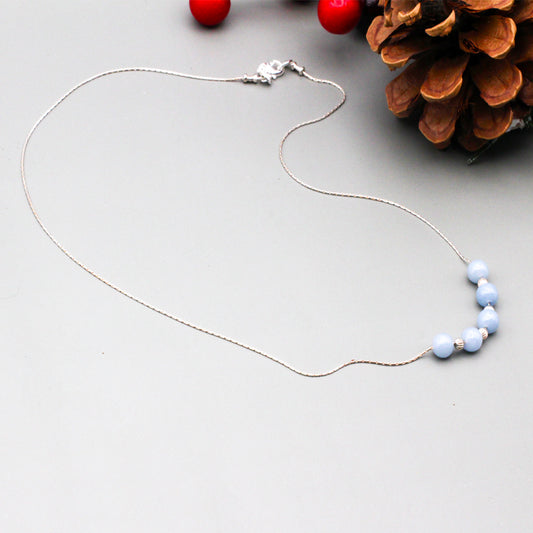 Angelite Gemstones and Rainbow Moonstones. The sterling silver chain finished with a lobster clasp closure.