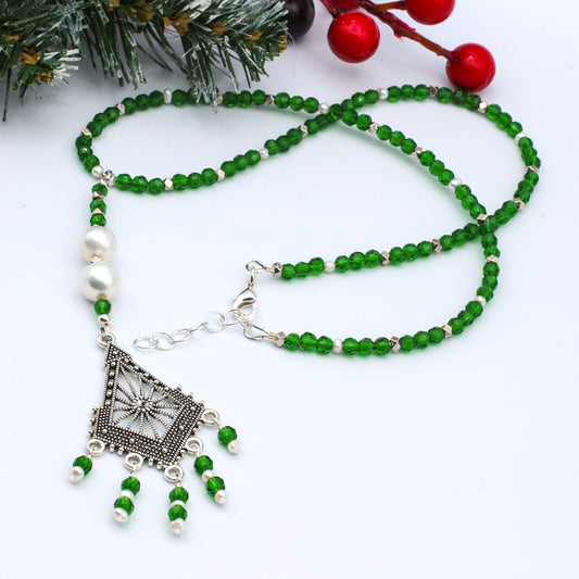 Featuring beautiful pearls surrounded by brilliant green crystals. A festive one to add to your special list.
