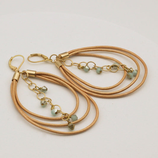 Hoop earrings with gold leather, mint green crystals, and matte gold chain.