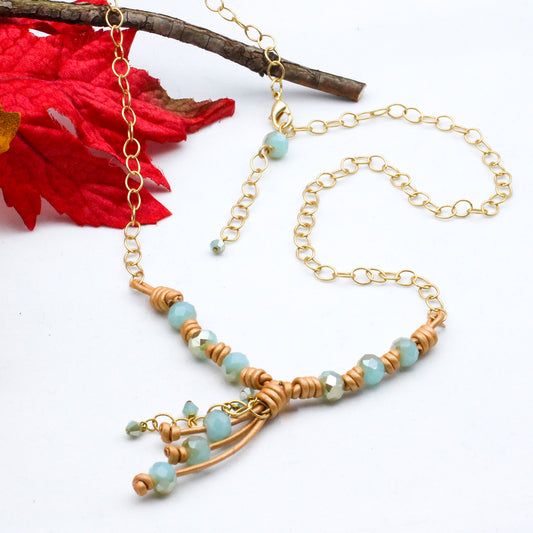 Necklace with mint crystals, gold leather, and matte gold accents and chain.