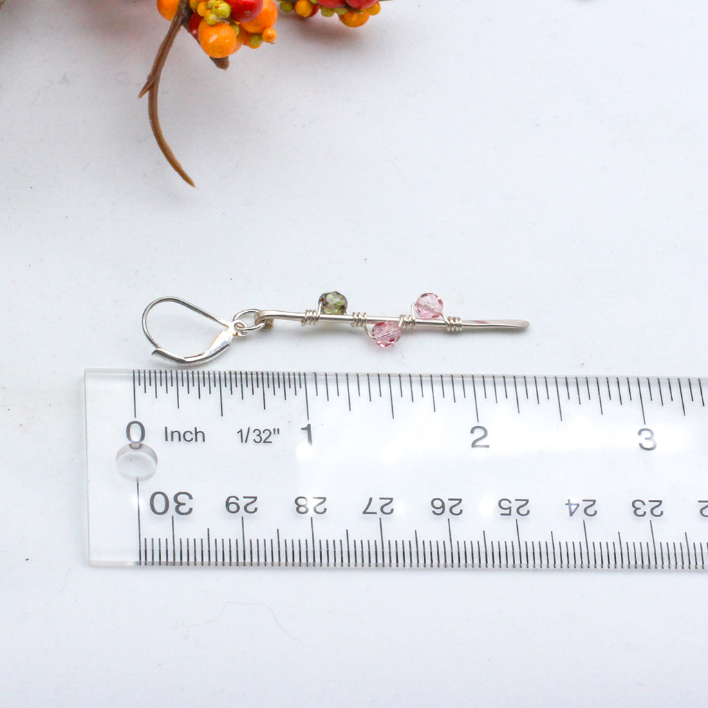 Hand-forged Sterling Silver bars adorned with vibrant Czech fire polish beads intricately wrapped around them. Completed with secure lever-back ear-wires.