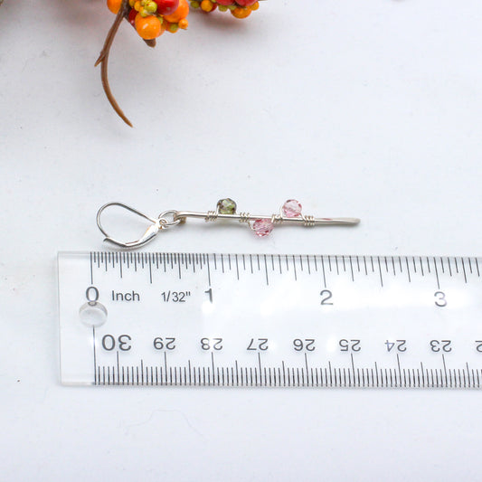 Hand-forged Sterling Silver bars adorned with vibrant Czech fire polish beads intricately wrapped around them. Completed with secure lever-back ear-wires.