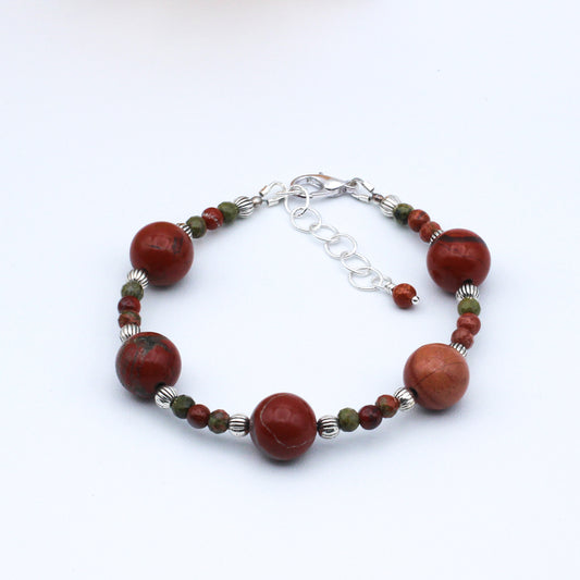 Expertly handcrafted from Red Creek Jasper gemstones. This bold accessory combines a refined design with a captivating look. Lobster clasp closure and extender chain.