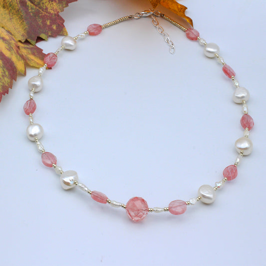 This elegant necklace is adorned with Freshwater Pearls, Cherry Quartz Gemstone, and Silver electroplated metals.