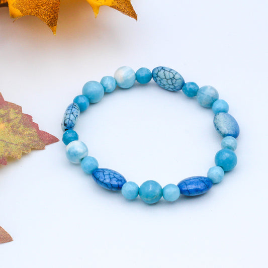The bracelet features a stunning combination of Larimar and Magnesite gemstones.
