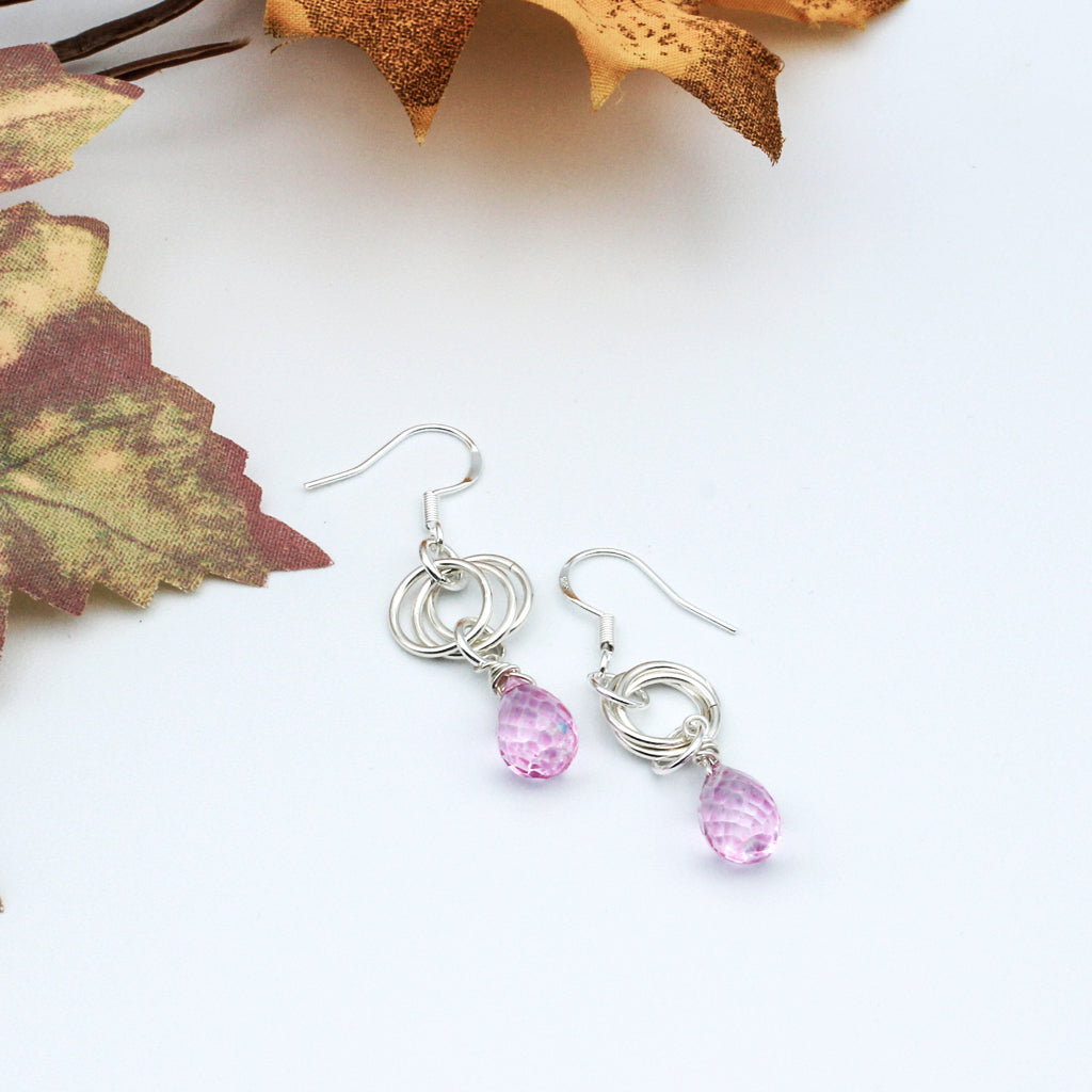 A timeless and understated piece. The Pink Quartz Faceted Briolette hang delicately from the triple loop Sterling Silver Rosette.