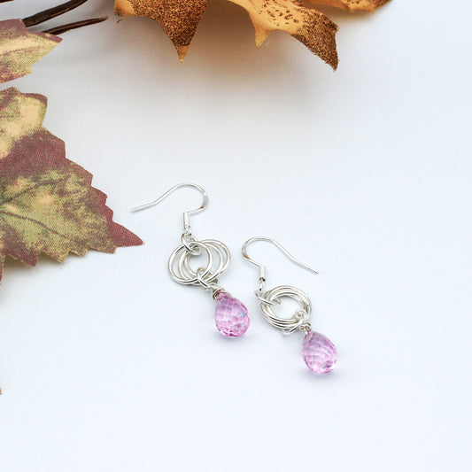 A timeless and understated piece. The Pink Quartz Faceted Briolette hang delicately from the triple loop Sterling Silver Rosette.