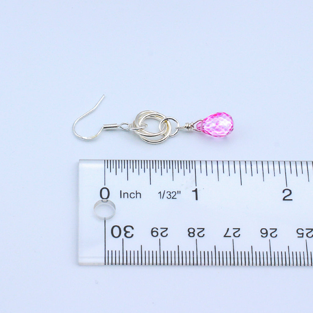 A timeless and understated piece. The Pink Quartz Faceted Briolette hang delicately from the triple loop Sterling Silver Rosette.