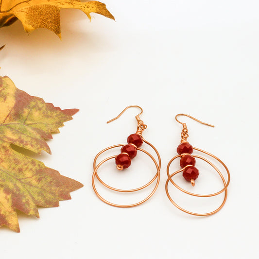 Hand-formed circle within circle earring design showcases the stunning combination of deep faceted crystals and jeweler's copper.