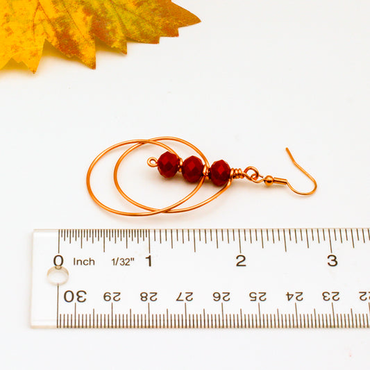 Hand-formed circle within circle earring design showcases the stunning combination of deep faceted crystals and jeweler's copper.