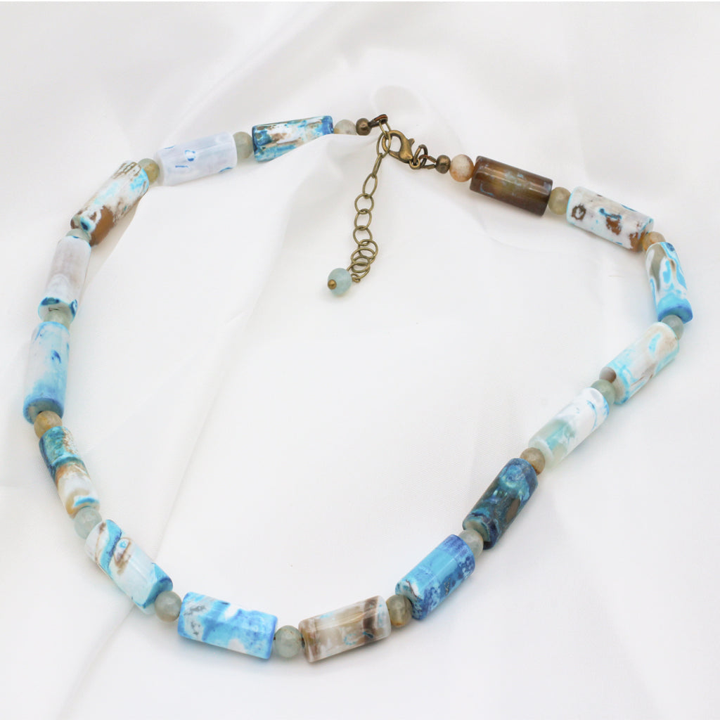 Agate Tubular Gemstones and Calcite Gemstones, accented with Antique Bronze metals. Necklace finishes with a Lobster Clasp Closure and 2" extender chain.