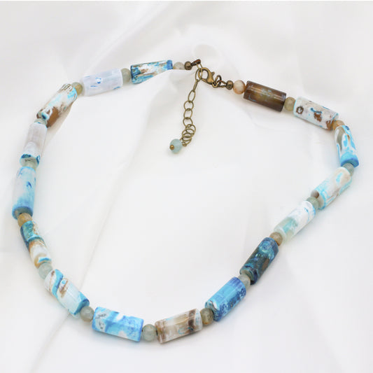 Agate Tubular Gemstones and Calcite Gemstones, accented with Antique Bronze metals. Necklace finishes with a Lobster Clasp Closure and 2" extender chain.