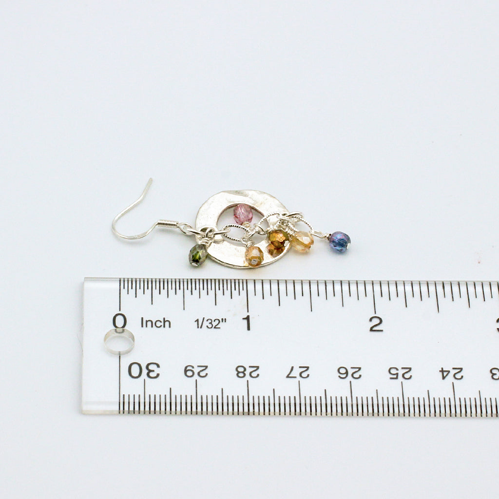 Soft pastel tones with these Bubbly Rose' earrings. Adorned with delicate crystals encircling a striking hammered disc centerpiece.