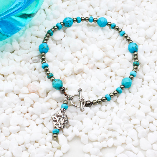 Turquoise Gemstones and Pyrite & Pewter metals finished with a toggle closure will elevate any outfit.
