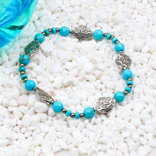 Turquoise Gemstones and Pyrite spacer beads, adorned with Pewter decorative elements on a stretch band.